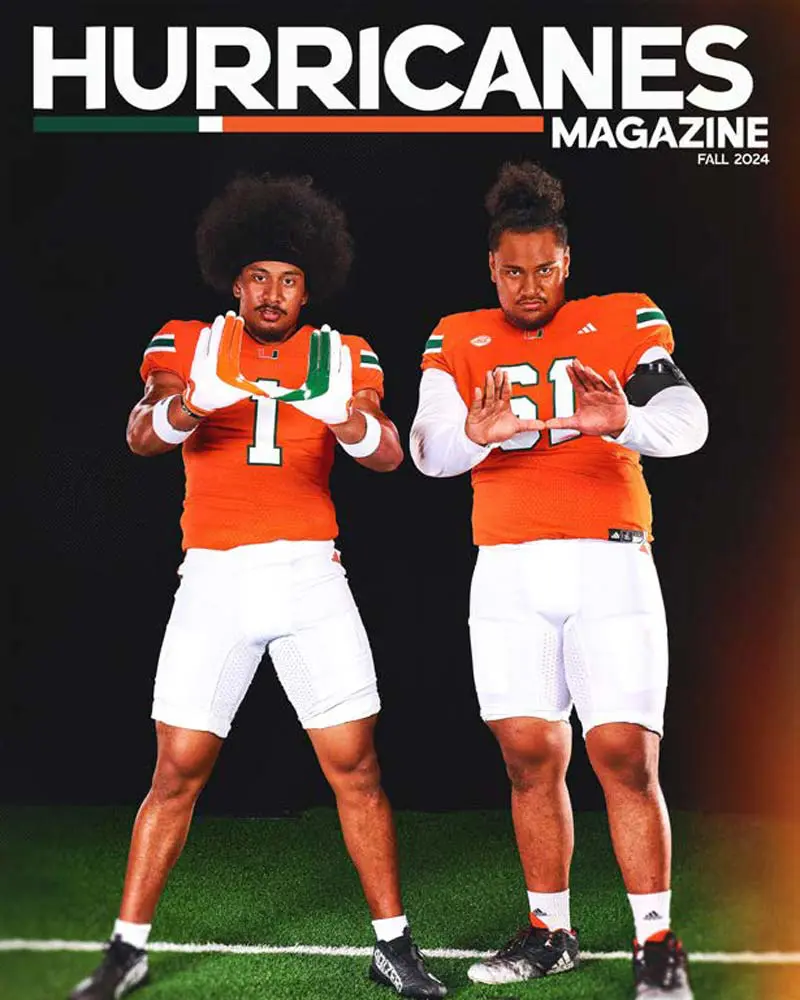 basketball player sitting on hoop with ball