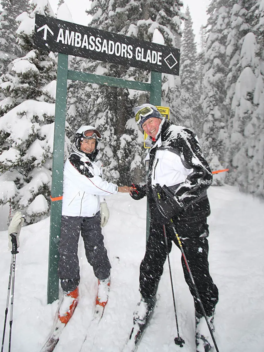 family posing in basketball arena