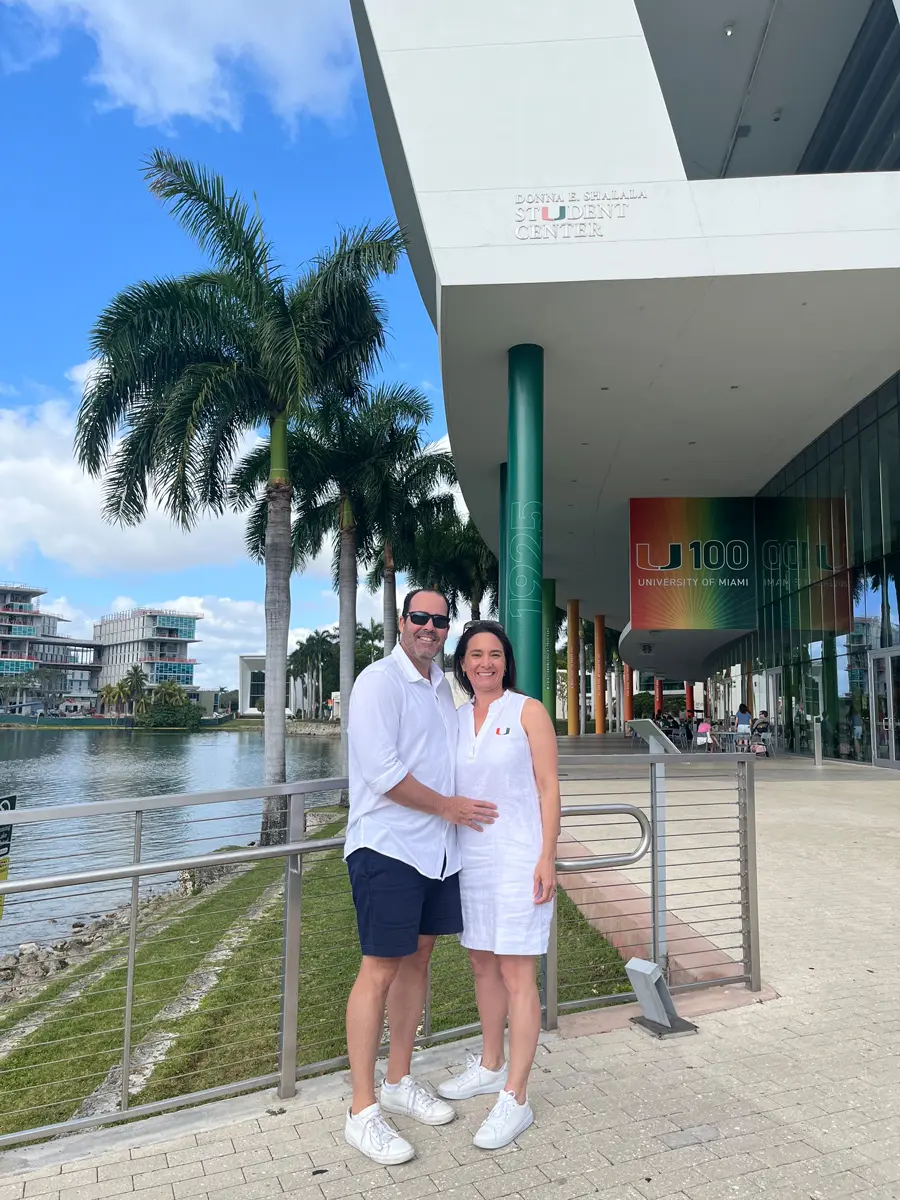 family posing in basketball arena