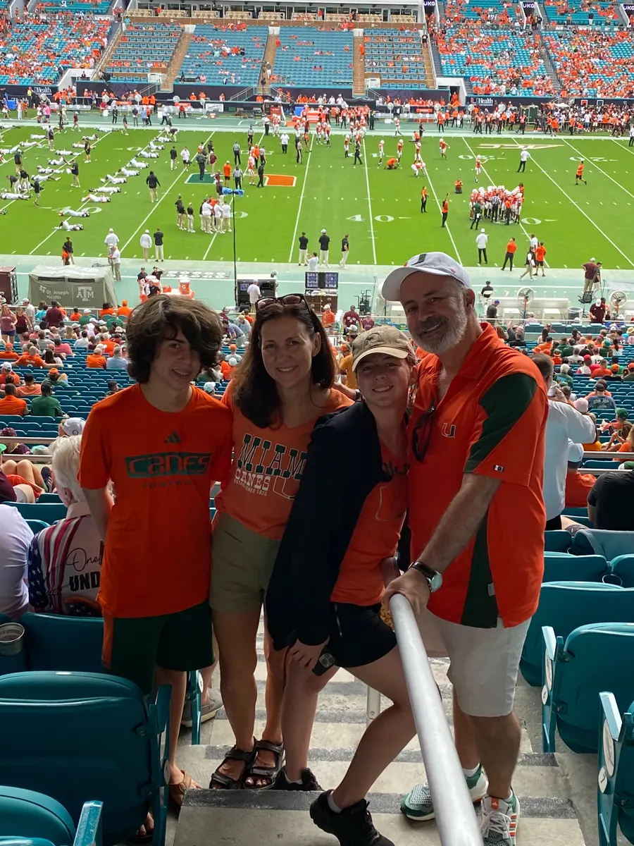 family posing with mascot