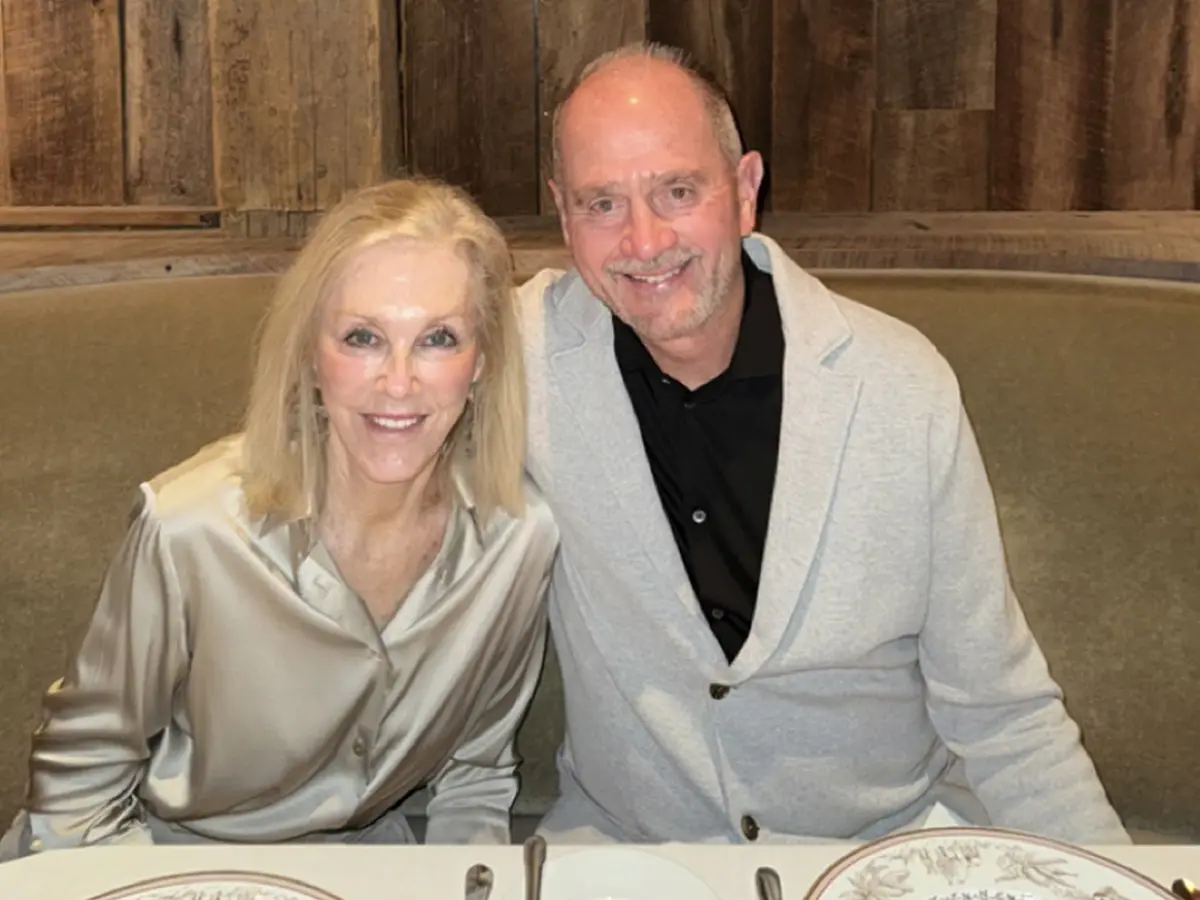 family posing in basketball arena