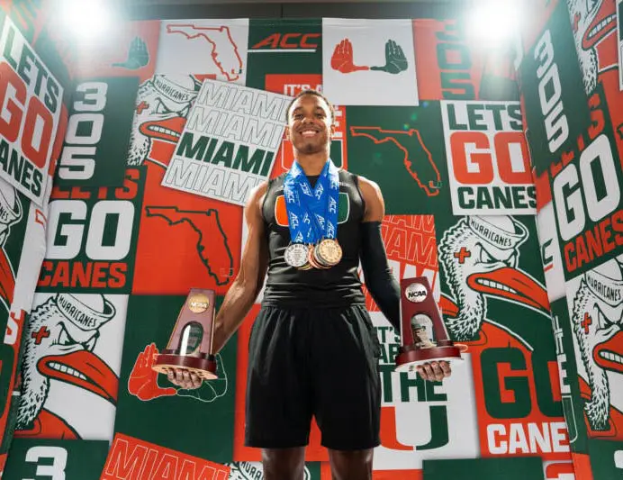 Athlete posing with trophies and medals
