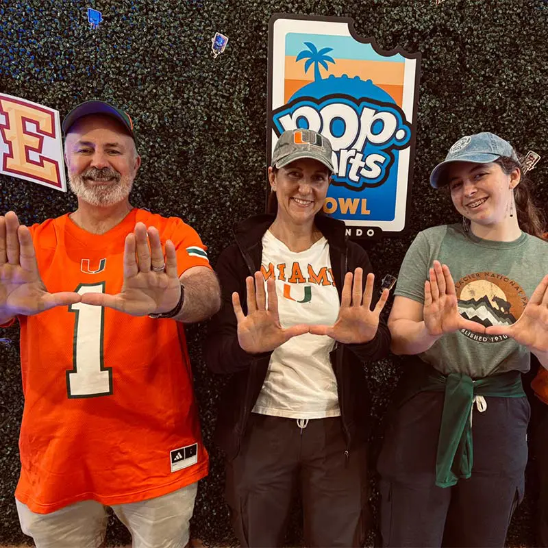Fans posing with the U at poptart bowl