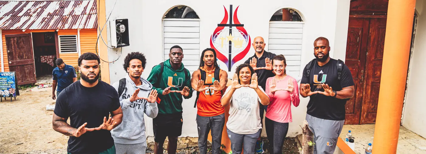 people making the U sing with their hands