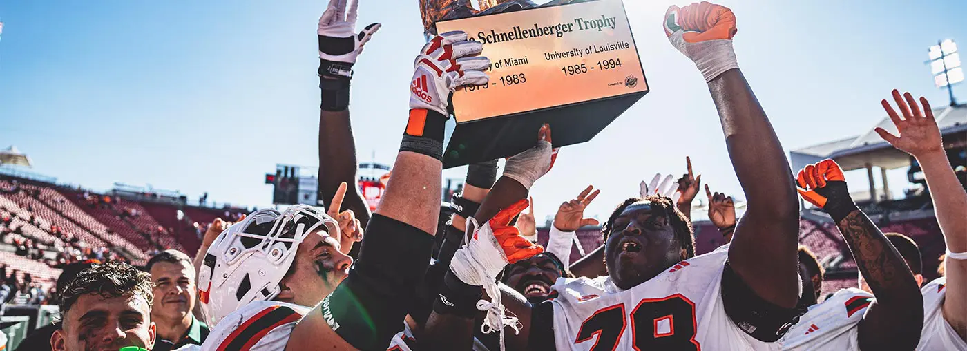 football players holding up trophy