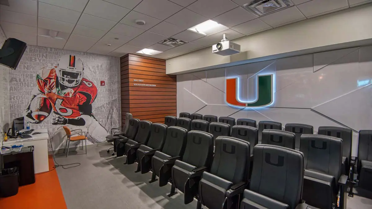 Inside of film room with chairs and 'U' sign
