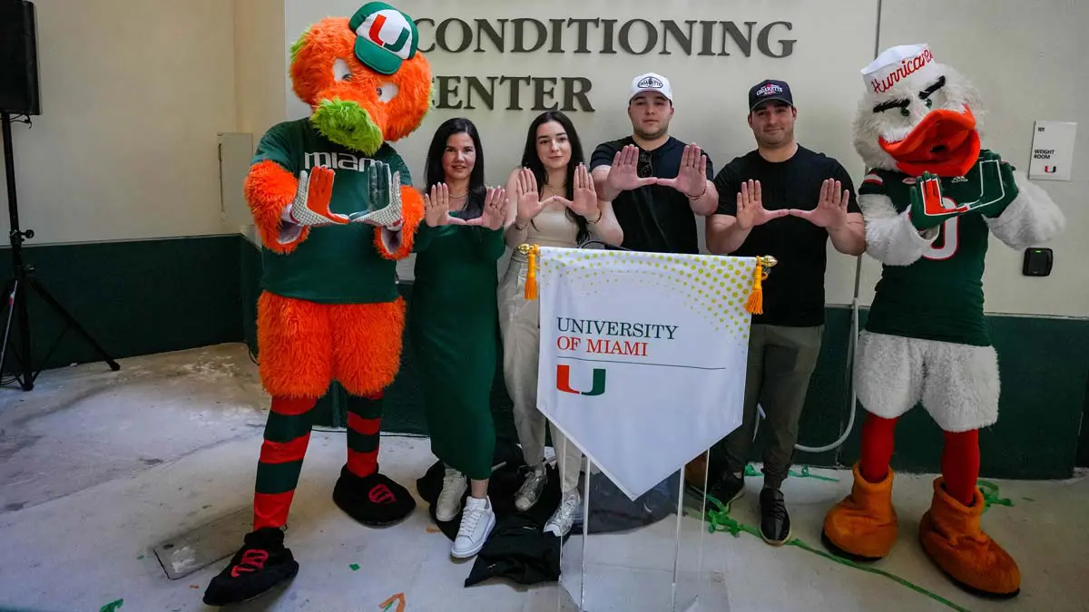 Mascots and two men and two women