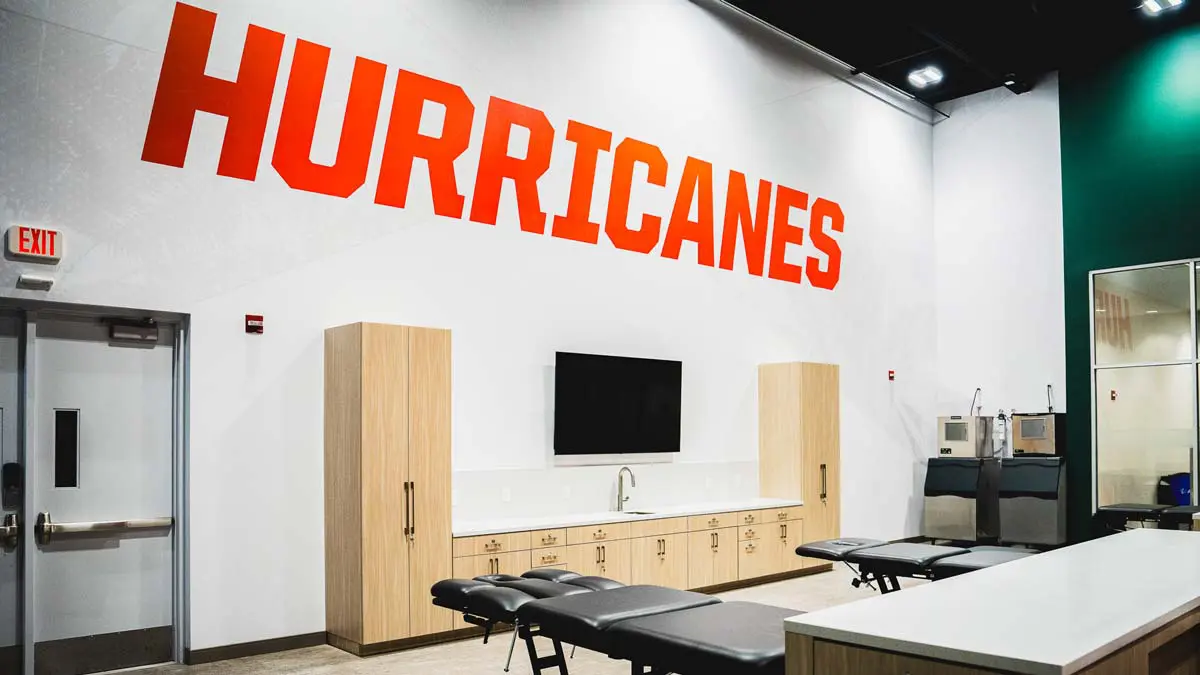 room with two massage tables in front of hurricanes sign